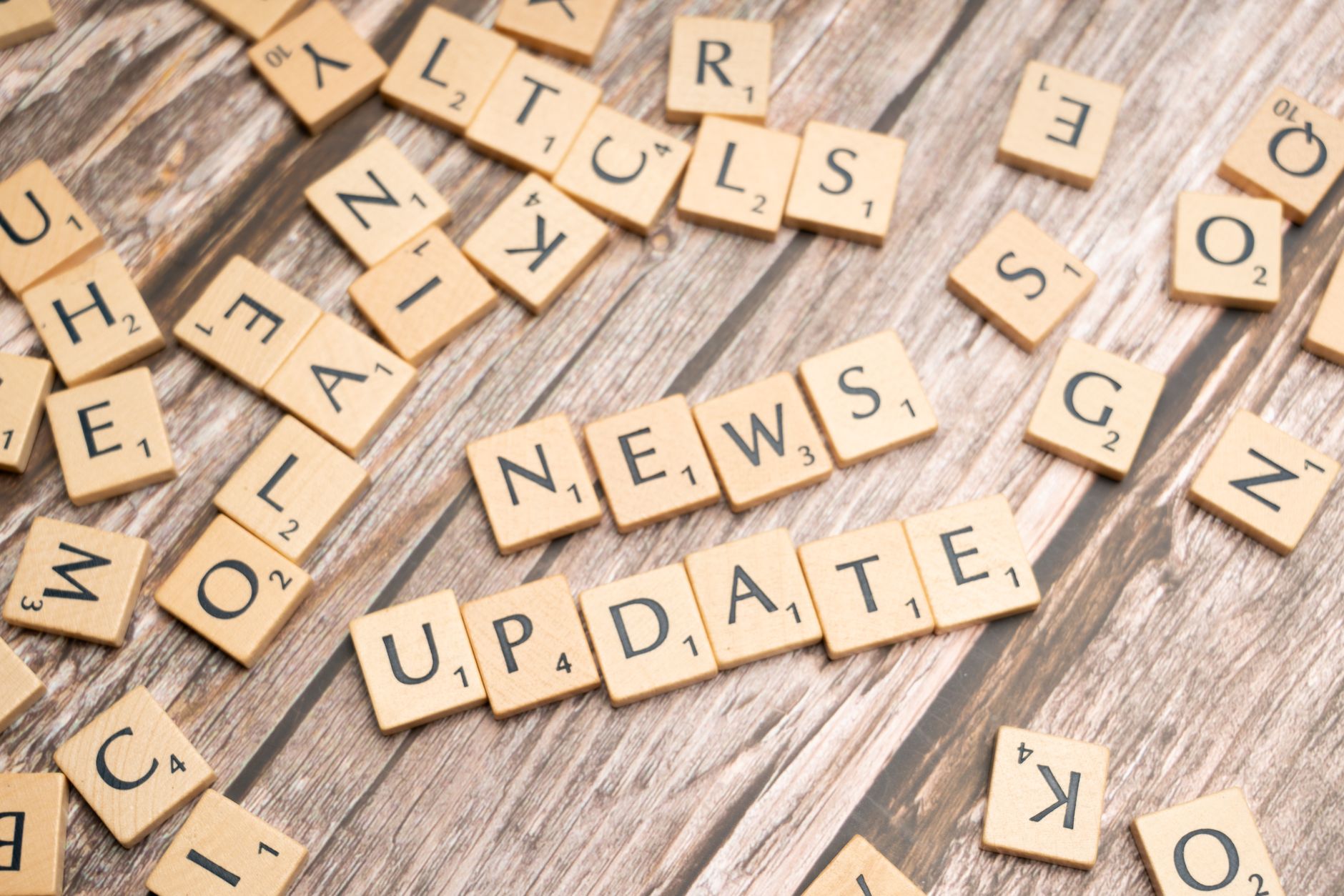 Scrabble tiles spelling 'News Update' on a wooden background, ideal for media and communication concepts. — Beep Beep Casino:
