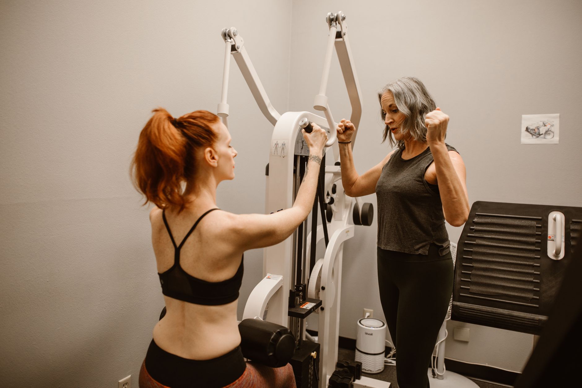 Two women working out with gym equipment indoors, focusing on fitness and healthy living. — Common Kinds of Fibula Fractures