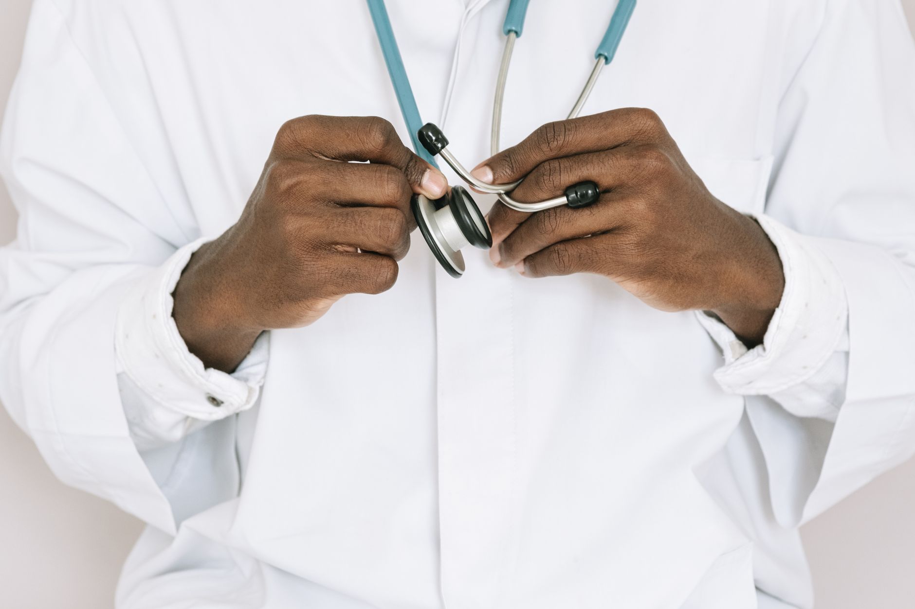 A professional doctor holding a stethoscope, focusing on hands and medical tools. — Repair Your Frozen Shoulder with Regenera
